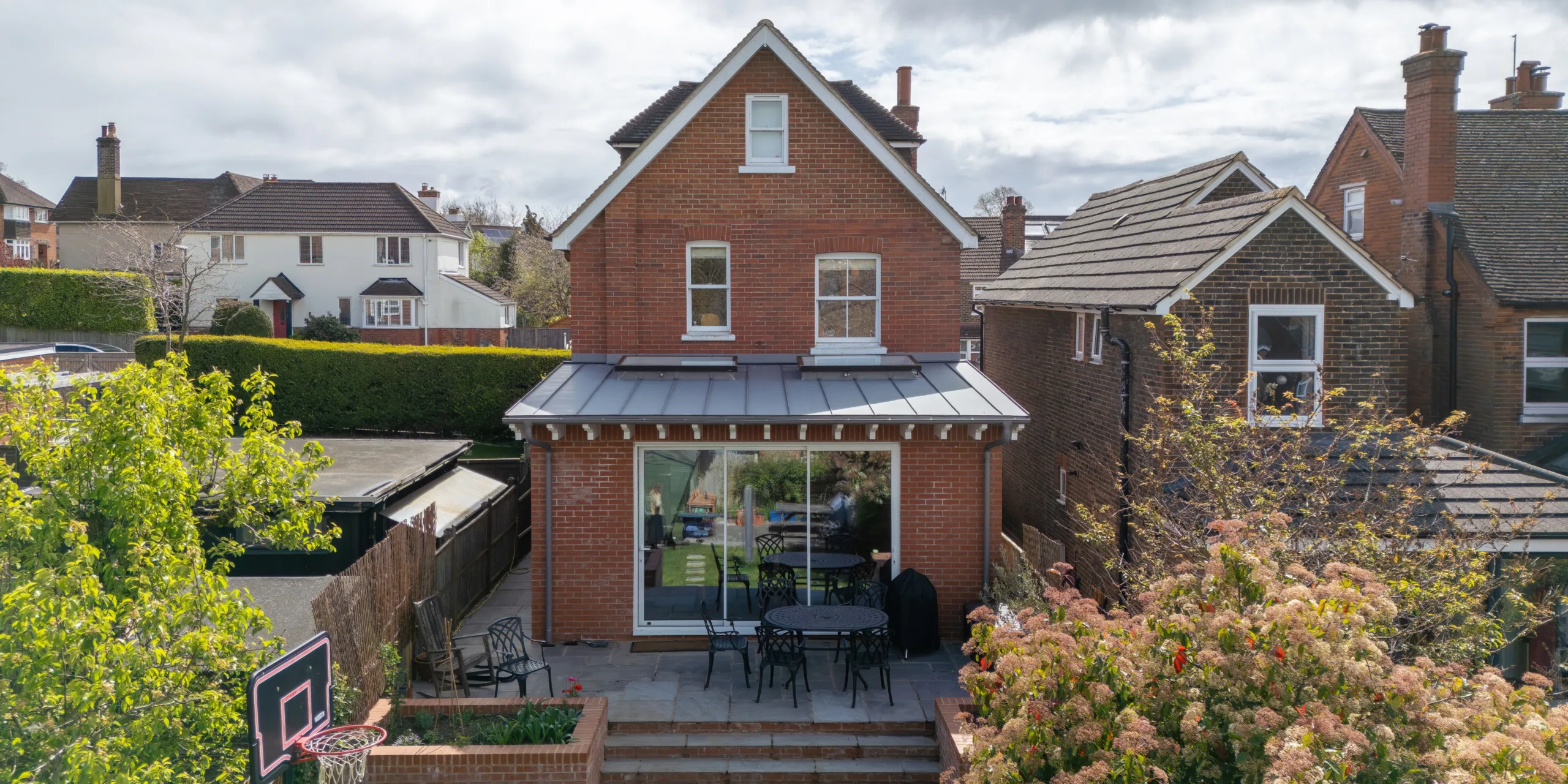Victorian rear extension in Redhill Surrey with large glazed doors, rooflights and brick detailing connecting kitchen to garden patio