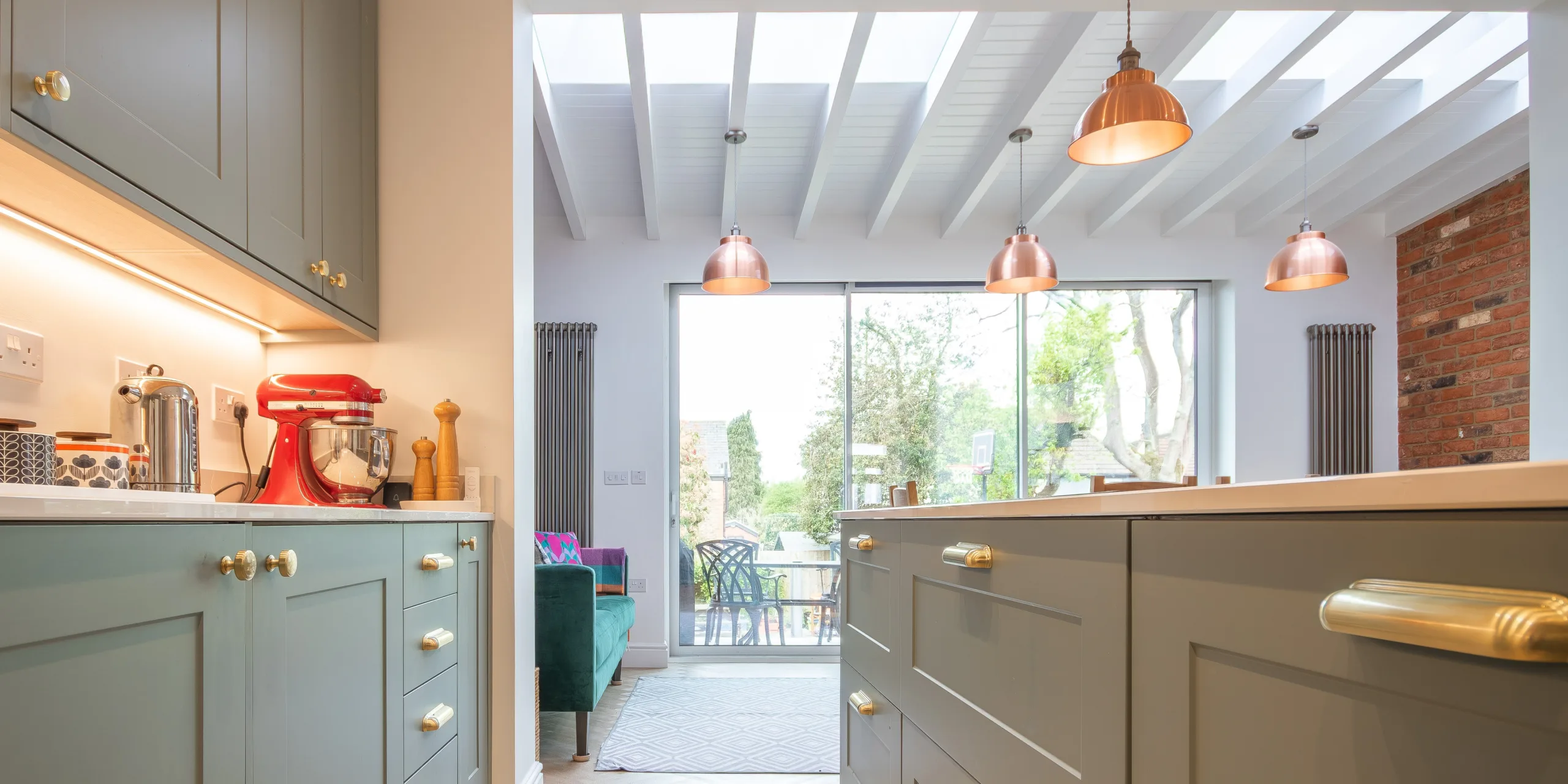 Open-plan kitchen dining space in Victorian extension with rooflights, island and natural light in Redhill Surrey