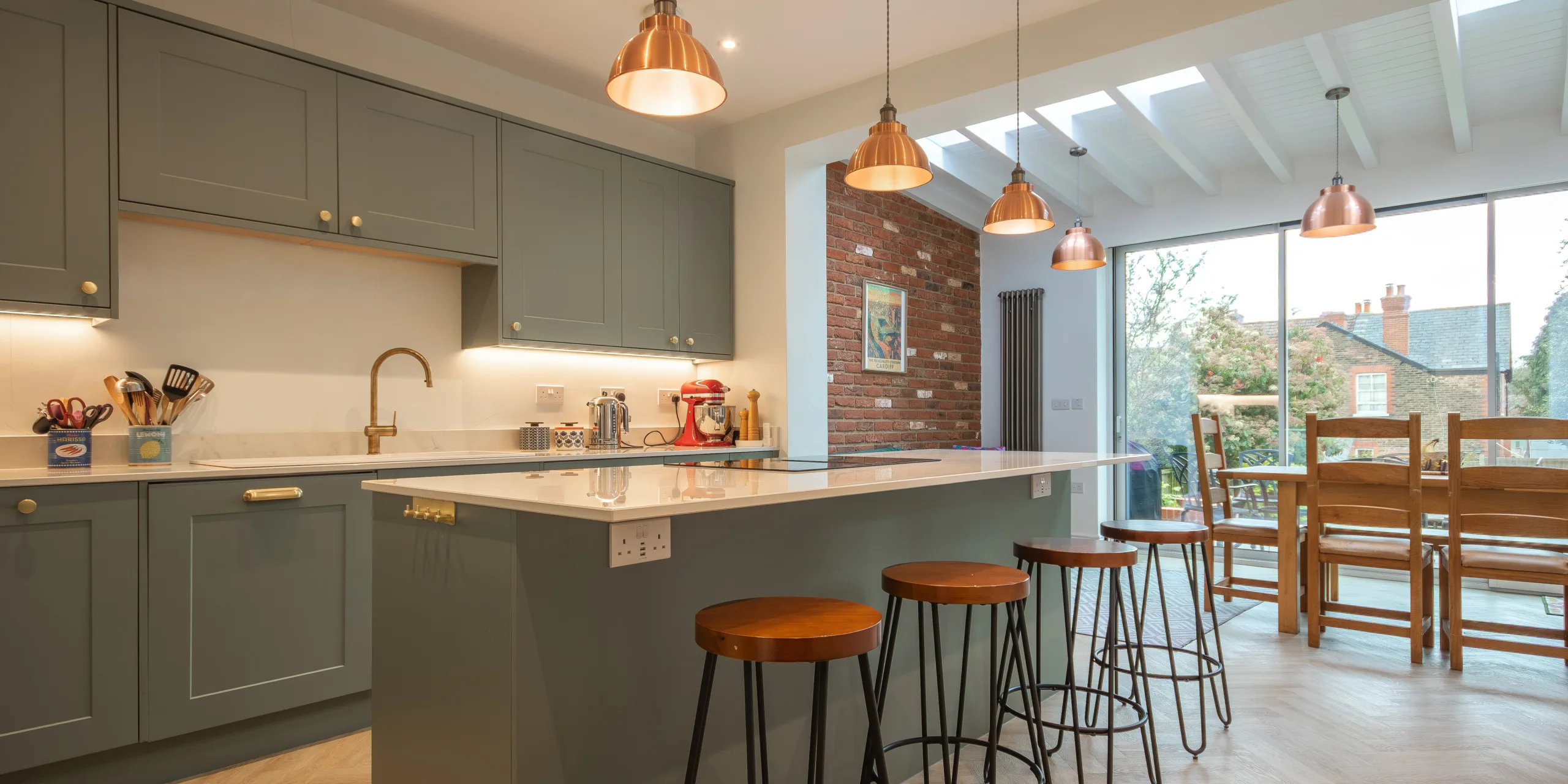 Open-plan kitchen dining space in Victorian extension with rooflights, island and natural light in Redhill Surrey