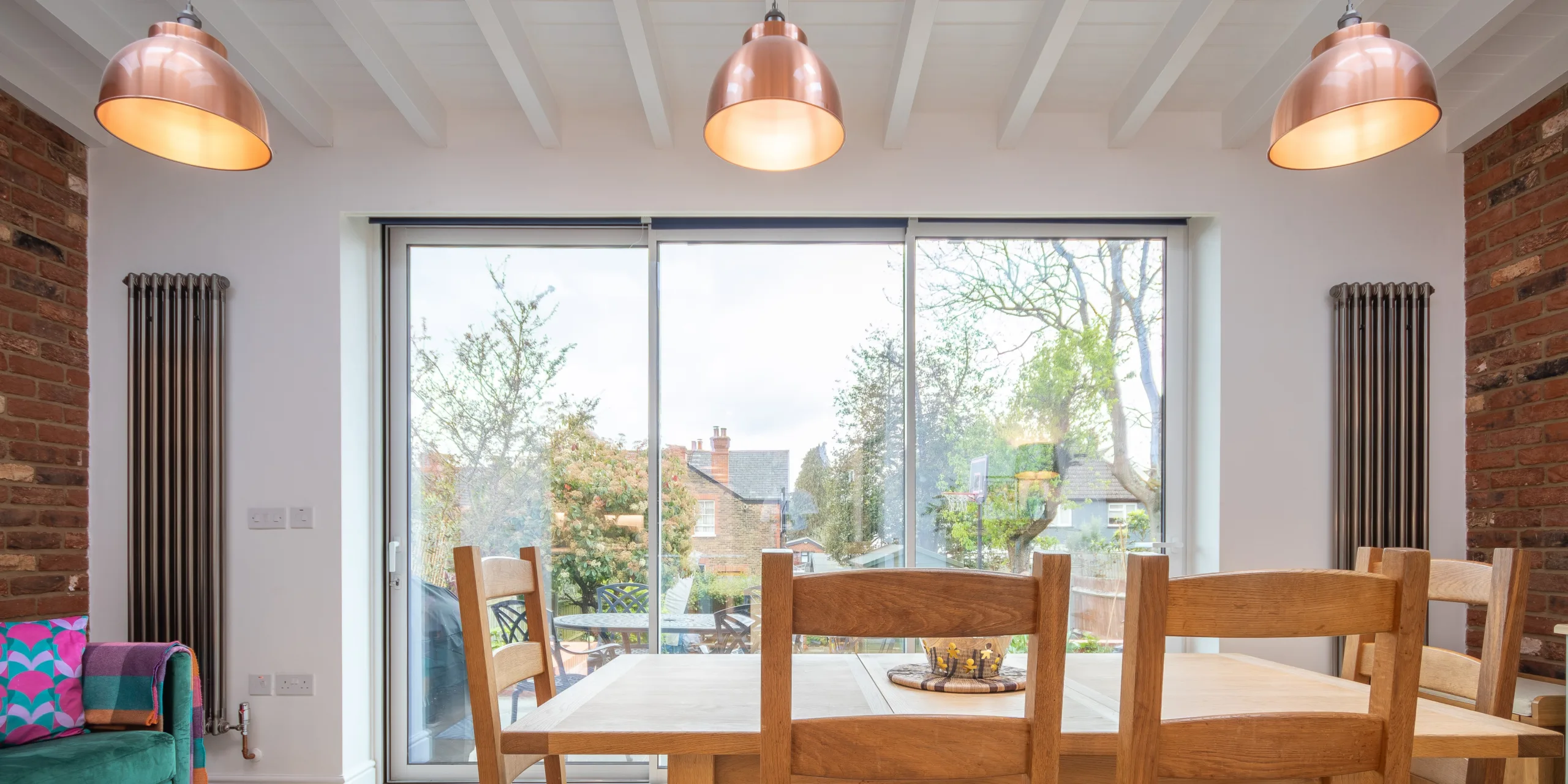 Open-plan kitchen dining space in Victorian extension with rooflights, island and natural light in Redhill Surrey