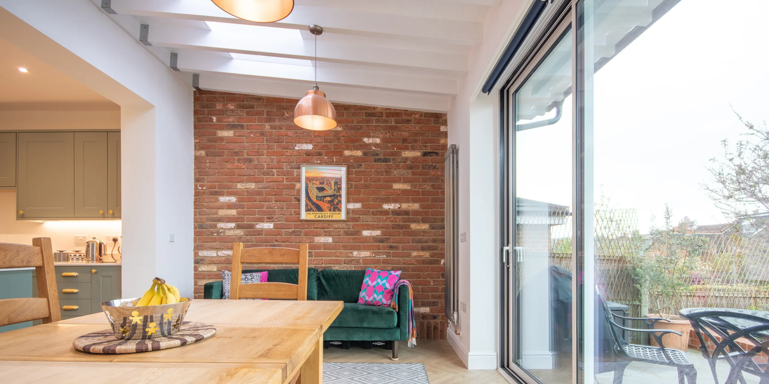 Open-plan kitchen dining space in Victorian extension with rooflights, island and natural light in Redhill Surrey