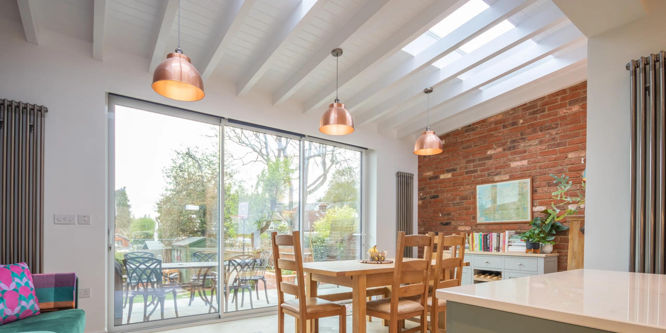 Open-plan kitchen dining space in Victorian extension with rooflights, island and natural light in Redhill Surrey
