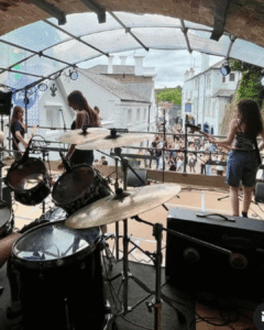 Live music performance on the Tunnel Stage during Reigate Summer Festival, celebrating local musicians, creativity and community in Reigate.